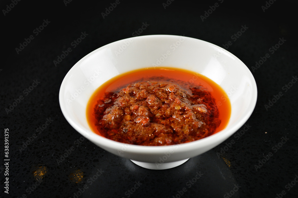chef signature mala red spicy chilli oil shrimp sambal paste sauce in bowl for laksa on black marble table asian halal food cuisine menu for restaurant chef signature mala red spicy chilli oil shrimp sambal paste sauce in bowl for laksa on black marble table asian halal food cuisine menu for restaurant