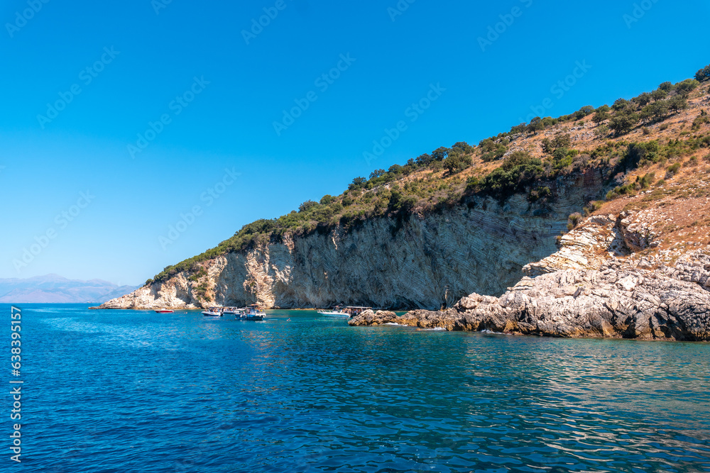 Gremina beach seen from the boat on the Albanian riviera near Sarande, turquoise sea water