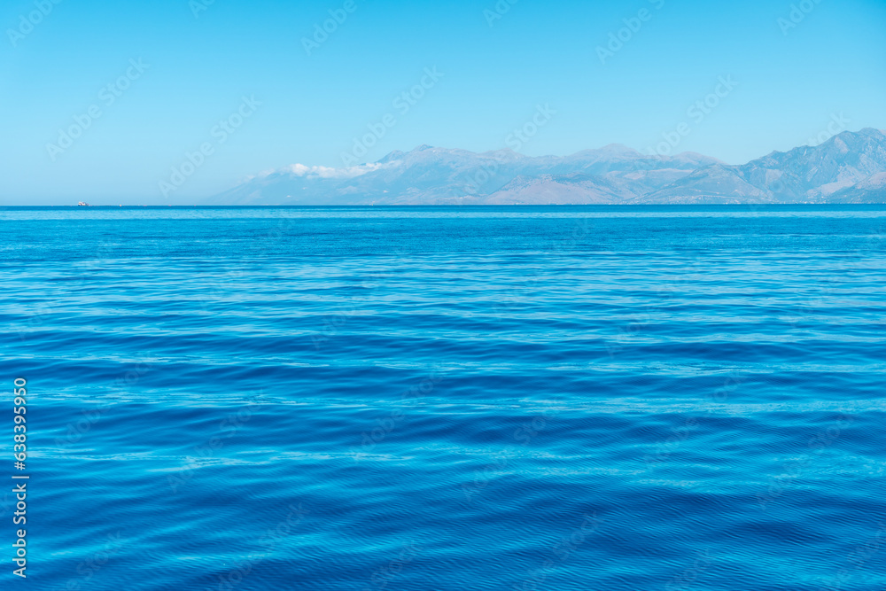 Turquoise sea water texture with sun rays in the mediterranean sea and sky background Turquoise sea water texture with sun rays in the mediterranean sea and sky background