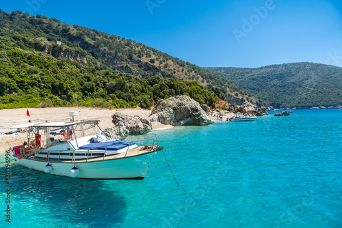  Boat in the transparent waters of the paradise beach of Kroreza or Krorez from the boat on the Albanian riviera in Sarande, Albania © unai