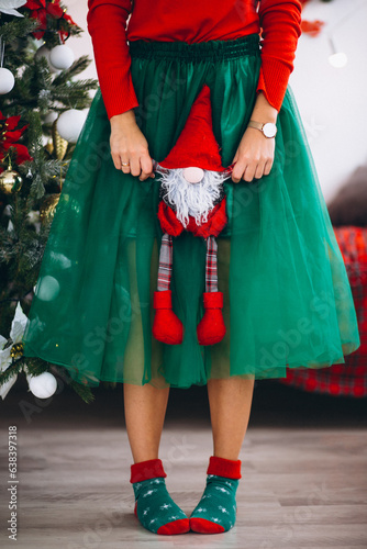 Woman holding little santa toy