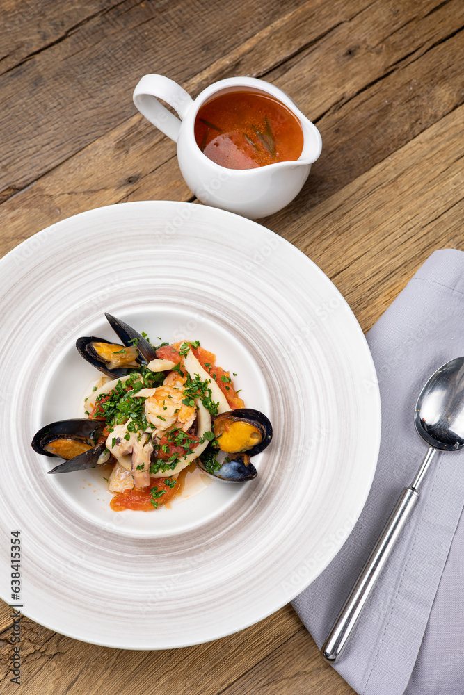 A delicious seafood soup in a restaurant. Close-up A delicious seafood soup in a restaurant. Close-up