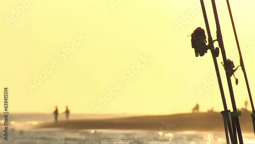 Fishing reels at sunset. Surfcasting photo