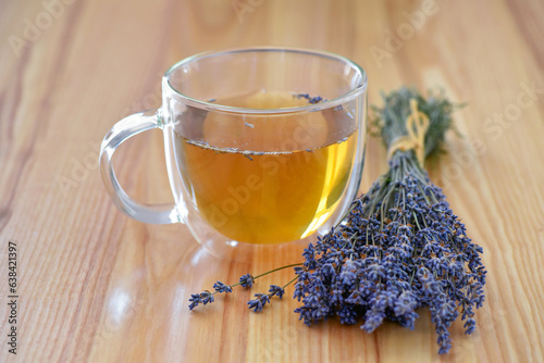 Cup of tea and lavender flowers on a wooden table