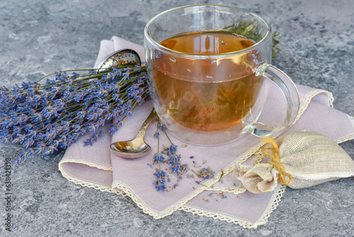Fresh delicious tea with lavender and lavender flowers on gray stone table