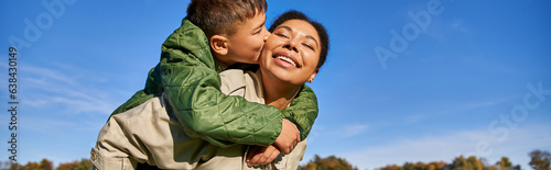 boy kissing cheek of mom, african american family, having fun together, bonding concept, banner