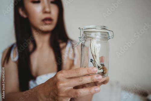 Woman holding jar of psychedelic mushroom