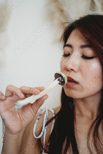 woman smelling psychedelic mushroom