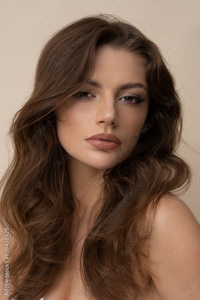 Studio shot of attractive young woman in brown sweater on brown background. Studio shot of attractive young woman in brown sweater on brown background.