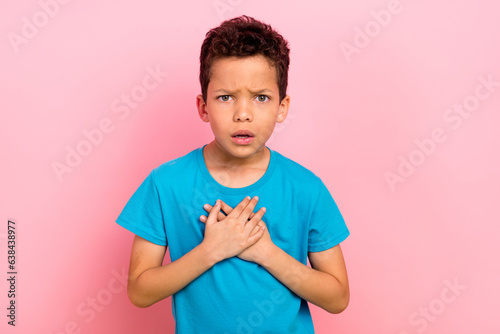 Photo portrait of charming small boy touch chest nervous stressed offended wear trendy blue garment isolated on pink color background