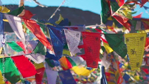 Slow motion shot of prayer flags waving in the wind at Kunzum Pass on the way to Kaza from Manali in Himachal Pradesh, India. Prayer flags at Kunzum surrounding the stupas in the Himalayan region.