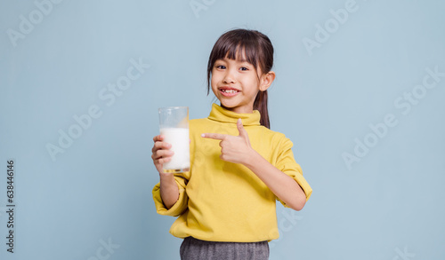 A little girl is drinking milk and very happy.