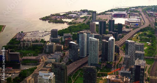 Immerse in urban life as bustling metropolis by waterfront comes alive. Parked yachts line the shores, while cars and trams weave through the streets, capturing the essence of life in the megapolis photo