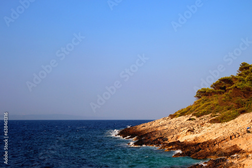 Beautiful wild beach on island Korcula, illuminated by warm sunset light.