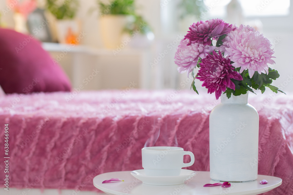 hot drink in white cup on background pink and white bedroom