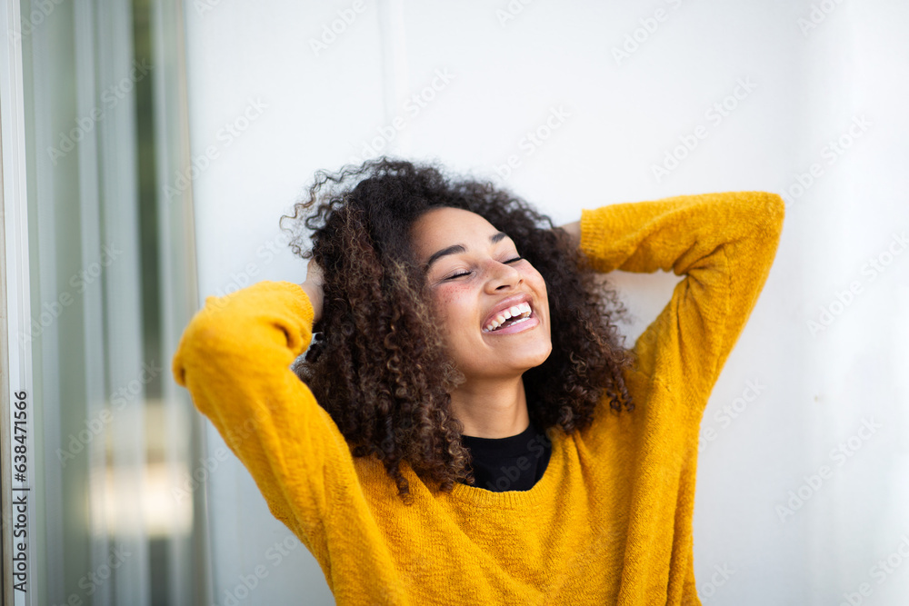 Close up happy young woman with hands behind head Close up happy young woman with hands behind head
