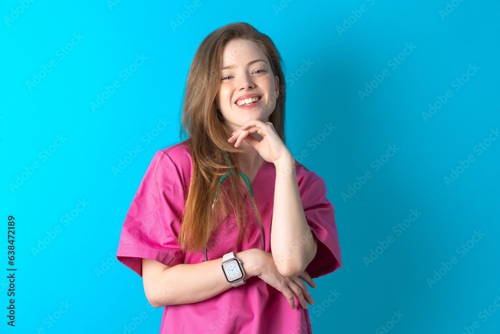 Optimistic young beautiful doctor woman keeps hands partly crossed and hand under chin, looks at camera with pleasure. Optimistic young beautiful doctor woman keeps hands partly crossed and hand under chin, looks at camera with pleasure.