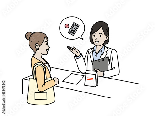 薬について説明する白衣を着た女性の薬剤師