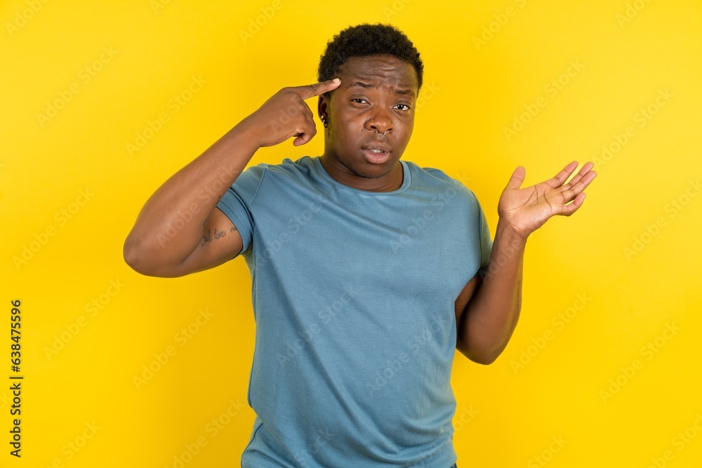 MODEL confused and annoyed with open palm showing copy space and pointing finger to forehead. Think about it. MODEL confused and annoyed with open palm showing copy space and pointing finger to forehead. Think about it.