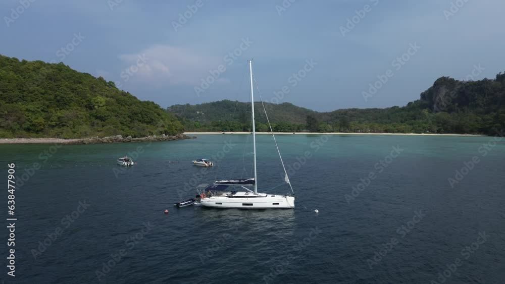 Sailing yacht in the sea against the backdrop of Phi Phi island, a sailing yacht stands near a tropical island, yachting in Thailand Sailing yacht in the sea against the backdrop of Phi Phi island, a sailing yacht stands near a tropical island, yachting in Thailand