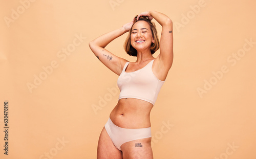Happy, lingerie and body of woman in studio isolated on a brown background mockup space. Smile, underwear and model in natural beauty, self love and confidence for positivity, health and wellness
