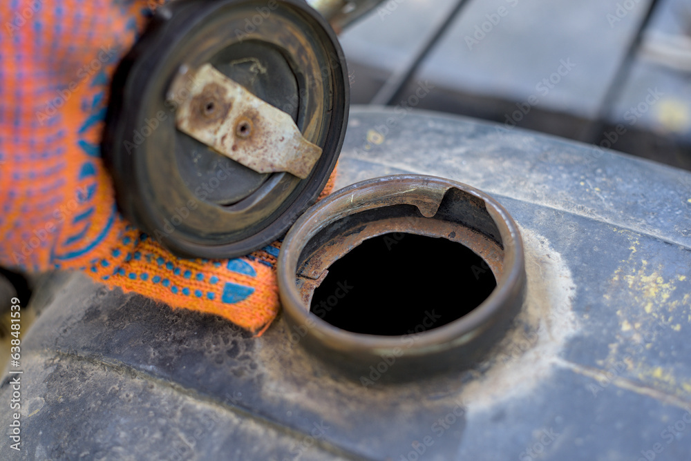 Hand holding motorcycle fuel tank cap