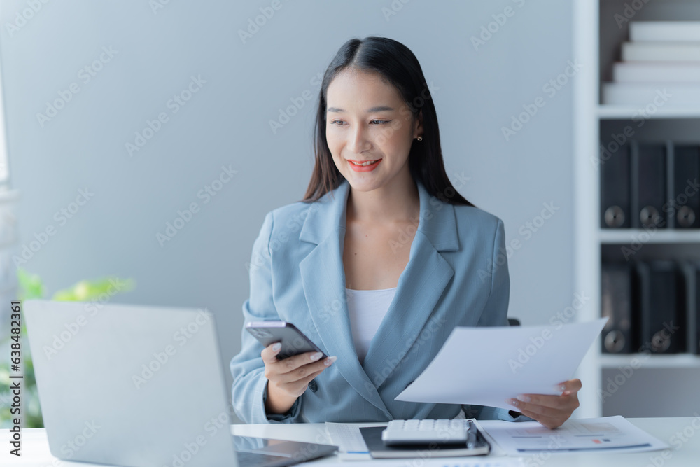 Shot of a beautiful young financial assistant sitting in front of laptop and fill the form in the office. Shot of a beautiful young financial assistant sitting in front of laptop and fill the form in the office.