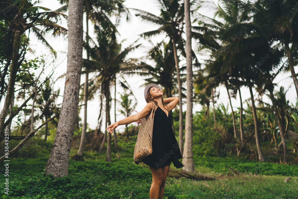 Carefree woman standing in park and enjoying sunlight Carefree woman standing in park and enjoying sunlight