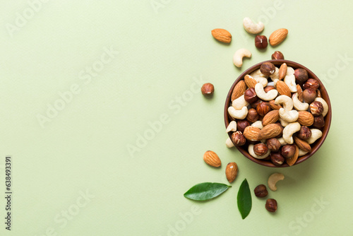 Valokuva Assortment of nuts in wooden bowl on colored table