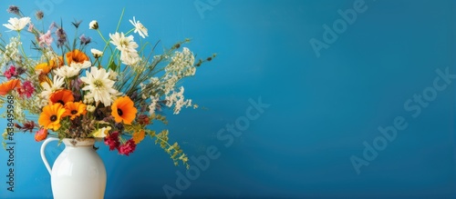 Wildflowers displayed in front of blue wall