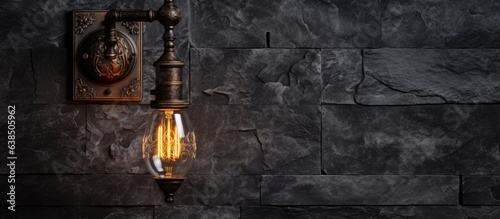Industrial wall lamp against dark stone wall
