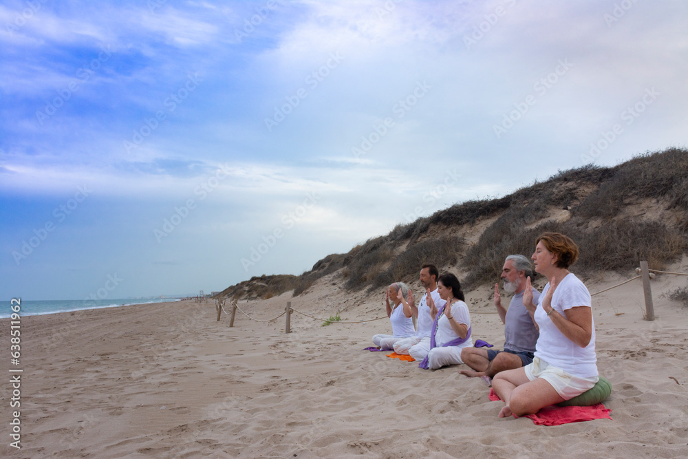 Practicing kundalini yoga on the beach