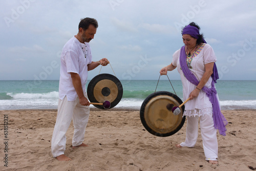 Man and woman with a gong in the beach