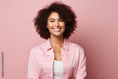 beautiful woman with afro hair smiling on a bright background, smiling portrait