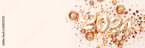 Banner with 2024 golden numbers and shiny stars confetti on a beige background. New Year concept with copy space.