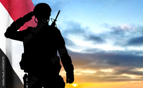 Silhouette of a soldier with Yemen flag against the sunset. EPS10 vector