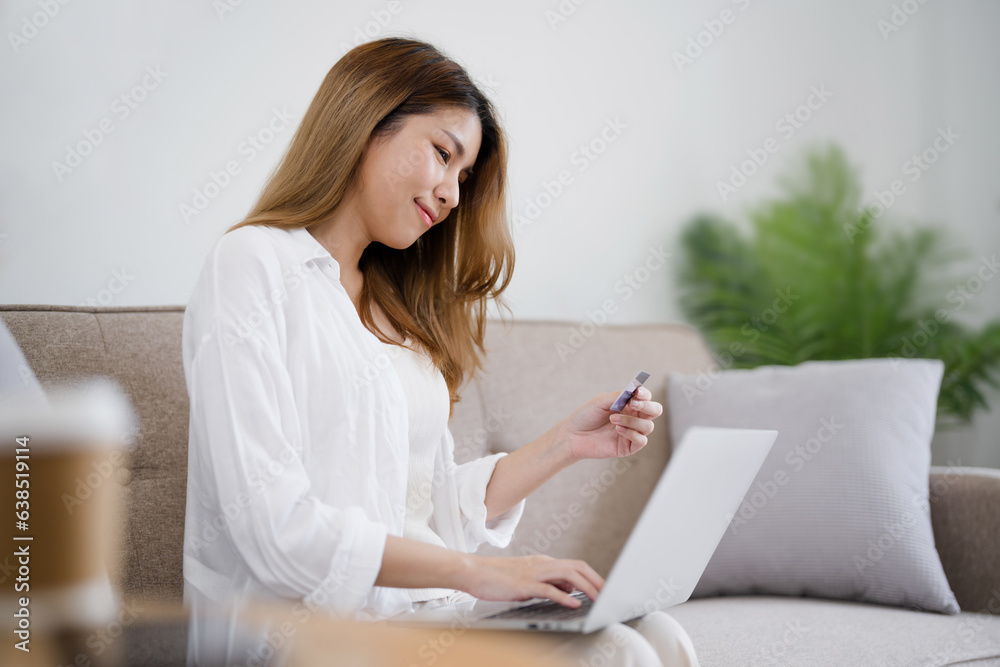 Happy asian woman using laptop and credit card for online payment, E-commerce Happy asian woman using laptop and credit card for online payment, E-commerce