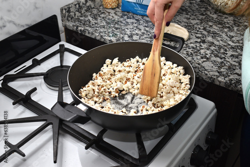 woman cooking popcorn at home to watch a movie