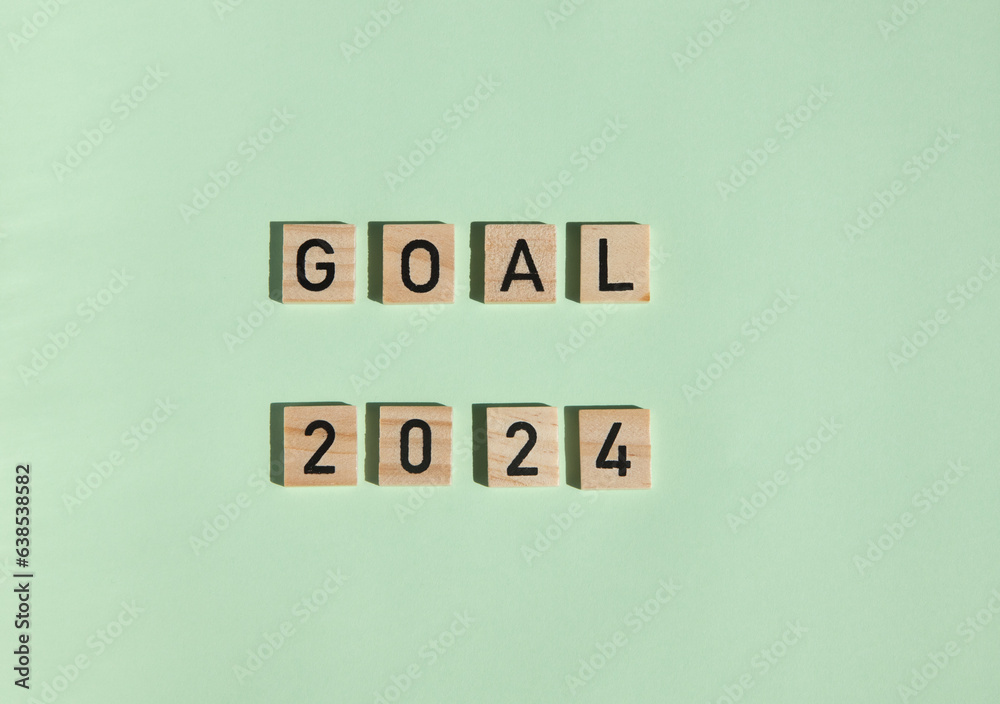 Wooden blocks 2024 on a green background. view from above. concept new plans, goals, motivation, reboot, countdown. a template for a postcard. happy new year Wooden blocks 2024 on a green background. view from above. concept new plans, goals, motivation, reboot, countdown. a template for a postcard. happy new year