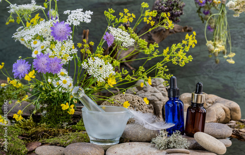 ecological bouquet, pipette bottles, pharmacological mortar, wild flowers, bouquet, bird feather, river stones, still life