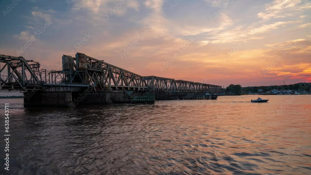 timelapse of a train passing over a railroad bridge at the mouth of the Connecticut river during a warm summer sunset timelapse of a train passing over a railroad bridge at the mouth of the Connecticut river during a warm summer sunset