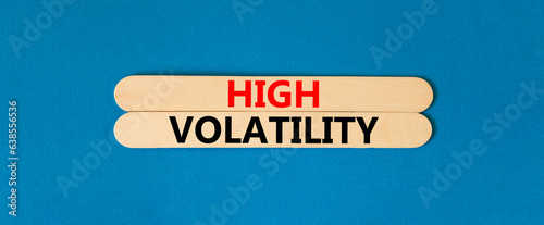 High volatility symbol. Concept words High volatility on beautiful wooden stick. Beautiful blue table blue background. Business high volatility concept. Copy space.