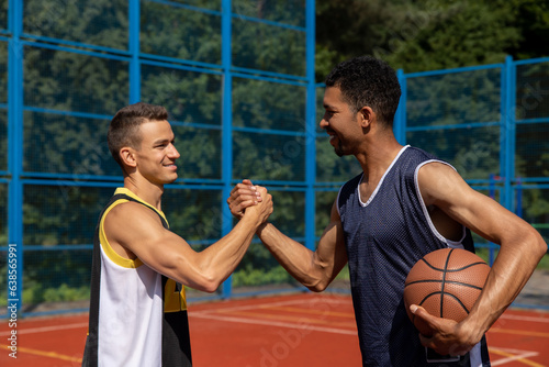 Athletic men friends on basketball court