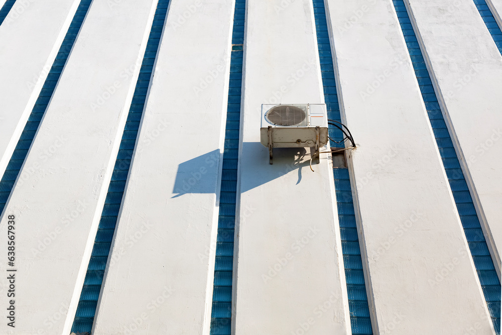 Heat pump. Air conditioning compressor on outside wall. Extra long shot, copy space.