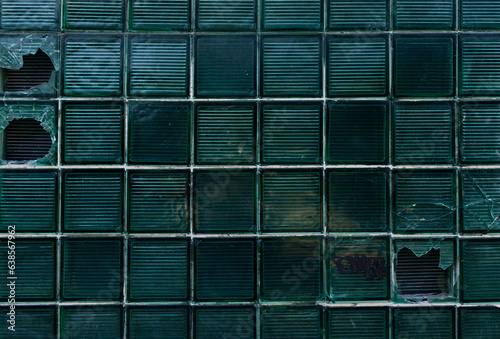 Obraz na płótnie Damaged glass block window at an infrastructure facility. Dark background. The concept of stealth. w salonie