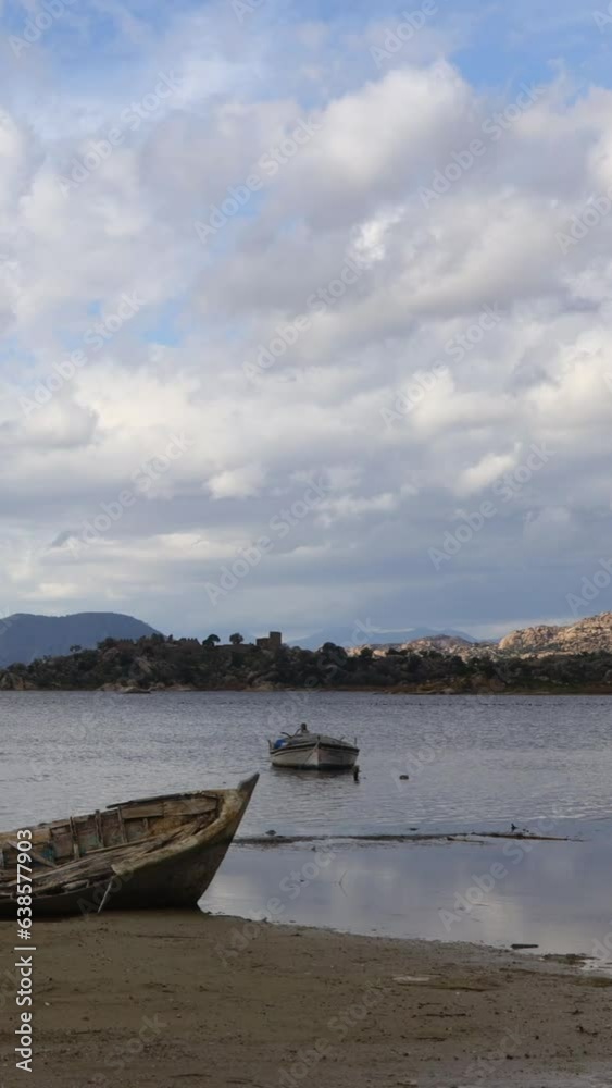 Fishing boats moored along the shore of Lake Bafa in Turkey. Vertical video for social media.
Fishing boats moored along the shore of Lake Bafa in Turkey. Vertical video for social media.