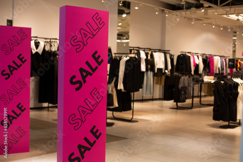 Bright purple anti-theft gate at the entrance to a clothing store with a black sale inscription. Discounts and promotions at the entrance to a modern clothing store on a metal detector