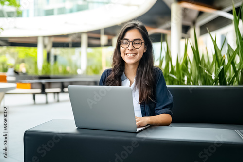 Portrait of happy business woman using laptop for work. Young female digital finance professional worker using computer doing corporate analysis online management. 