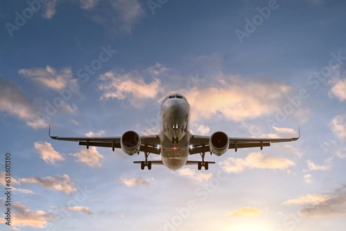 A large passenger airliner comes in to land there against the backdrop of a beautiful sunset sky.