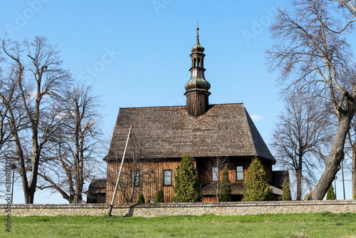CHABOWKA, POLAND - APRIL 22, 2023: The Holy Cross wooden church in Chabowka, Poland. photo